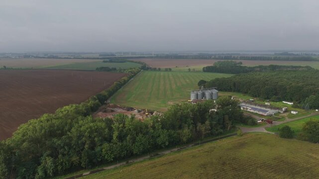 Farm Silos Among Green and Plowed Fields on Ruegen Drone View
