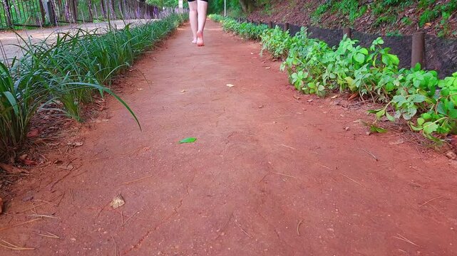 Barefoot Walking on Red Clay Dirt Trail in Park