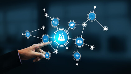 Fototapeta premium A modern digital network image featuring a hand pointing towards interactive icons representing communication, connection, and data sharing in technology. Tessel