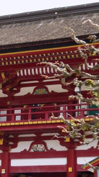 Dazaifu Tenmangu shrine complex in Dazaifu City, Fukuoka Prefecture, Roumon gate main entrance with gardens and nearby temples, Kyushu Island, Japan, red and white traditional Japanese architecture 