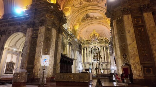View of the presbytery and the historic gold-leaf main altarpiece inside the Metropolitan Cathedral of Buenos Aires.