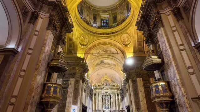 Overview displaying the ornate ceiling dome, golden pulpits, and main altar inside the Metropolitan Cathedral in Buenos Aires.