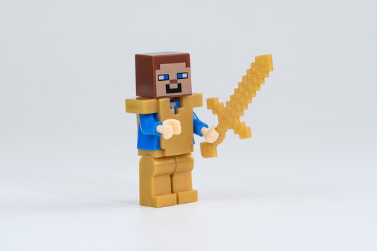 Minecraft Steve toy figure wearing gold armor and holding a gold sword, photographed against a plain white background on Sep 20, 2026 in Jakarta, Indonesia