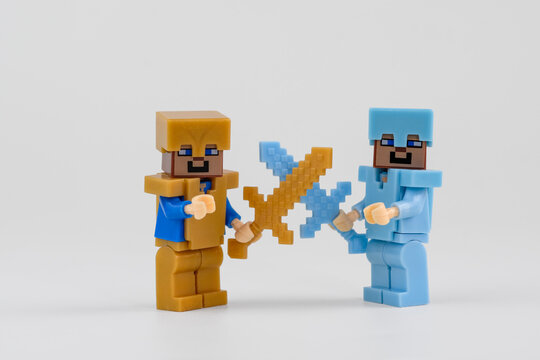 Minecraft character toy figures facing each other with crossed pixel style swords in a staged gaming battle scene on Sep 20, 2026 in Jakarta, Indonesia