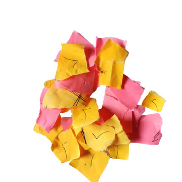 A pile of messy crumpled yellow and pink sticky notes with question marks written on paper scraps isolated on transparent background