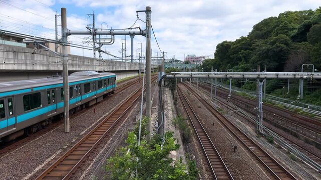 Keihin-Tohoku Line Train Passing Along Multiple Tracks Near Oji Station in Tokyo