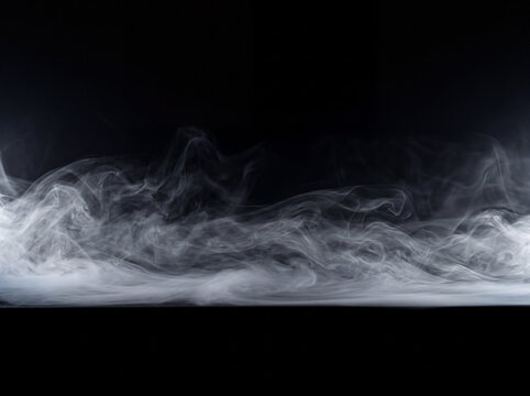 Thick white smoke and dense fog rolling low across the floor isolated on a solid black background, cinematic mist overlay texture.