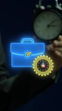 Businessman holding analog alarm clock vertical shot with glowing briefcase and compass gear. Career time management optimization, professional navigation direction, and strategic planning concept.