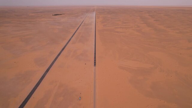 Cinematic Aerial View of a Long Train Crossing the Mauritanian Sahara