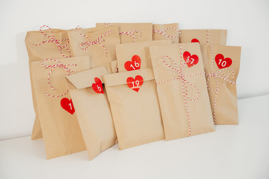 closeup photo of handmade advent calendar bags with numbers on white background.Christmas concept