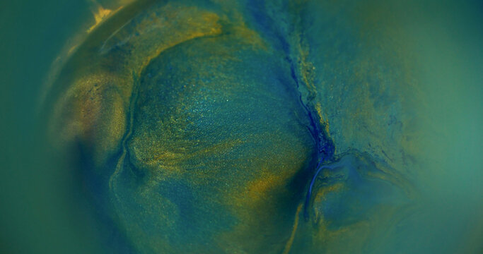 Blur ink texture. Color glitter pigment. Yellow blue green swirl paint bright fluid round liquid rainbow spill on abstract background.