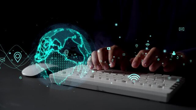 A close-up view of hands typing on a keyboard with an illuminated digital globe and floating technological icons, depicting connectivity in a modern digital workspace. Xenic