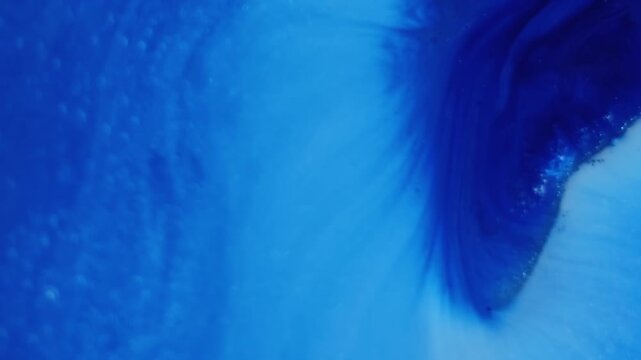 Paint fluid. Pigment liquid. Blue acrylic stream mix blend. Color fizz splatter diffusion abstract emulsion spread defocused background.