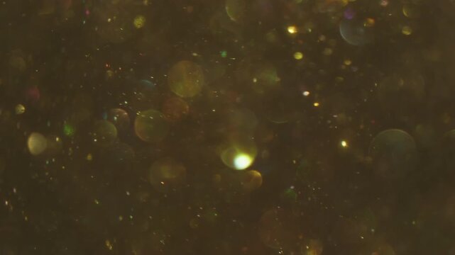 Radiant sparkling blur. Color bokeh blink. Yellow shimmering snow stream on purple abstract background. Flicker circles reflection mix.
