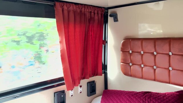 Sleeper Bus Interior With Comfortable Berth Bedding and Window Curtains