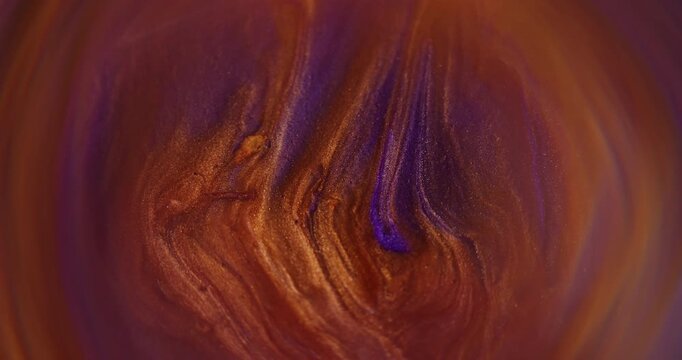 Defocused dye flow. Glitter blend. Orange purple color sparkling paint acrylic pigment shiny round water spill on abstract art background.