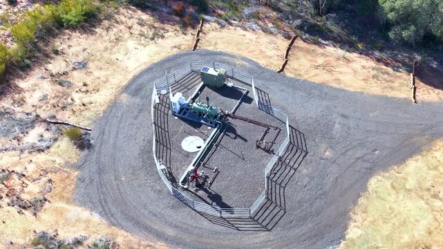 Aerial View of Fenced Gas Well Infrastructure in Bushland