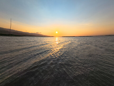 Golden Sunset Over Calm Tropical Lake