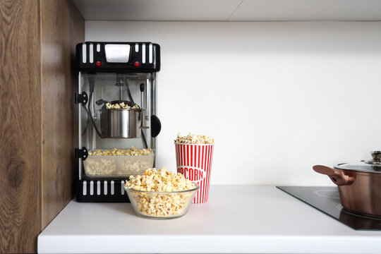 Modern popcorn machine on counter in kitchen