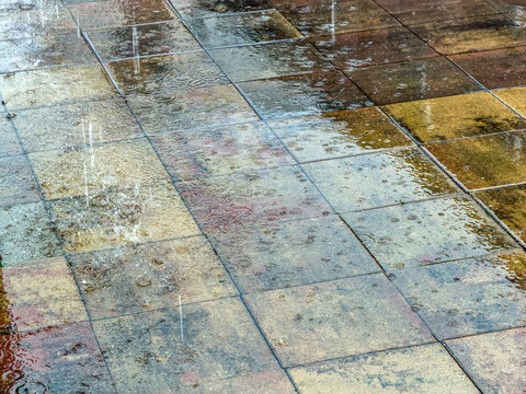 heavy rain. falling and splashing raindrops on wet pavement during rainy weather.