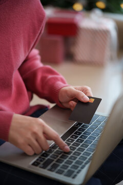 Close-up of a person calculating taxes and reviewing financial documents with a calculator and pen, representing accounting, debt, expenses, budgeting, bookkeeping and financial planning.