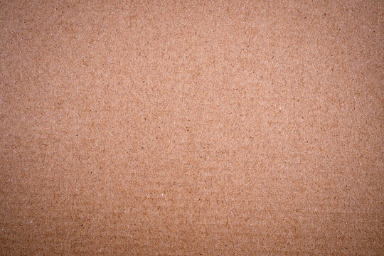 Brown kraft paper texture background, old recycled cardboard sheet surface.