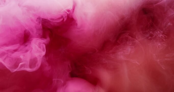 Color smog splash. Pink paint texture. Defocused red vibrant art particles chemical underwater fog water pigment spreading on acrylic abstract background.