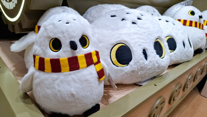 Fototapeta premium Official Harry Potter Hedwig snowy owl plush doll with Gryffindor scarf on display shelf in Miniso land on September 16, 2026 in Bangkok,Thailand 