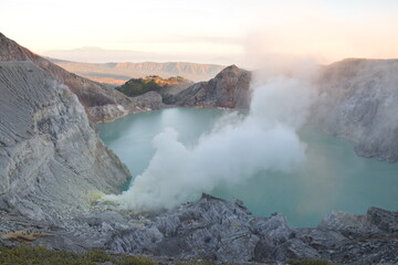 The beauty of Mount Ijen, with smoke rising from the crater against the backdrop of a green lake. © DODO HAWE