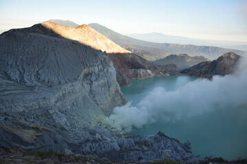 The beauty of Mount Ijen, with smoke rising from the crater against the backdrop of a green lake. © DODO HAWE