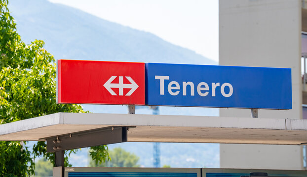SBB CFF FFS Railway Station Sign in Tenero Switzerland with Red Logo and Blue Nameboard on Sunny Day Against Clear Sky