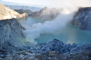 The beauty of Mount Ijen, with smoke rising from the crater against the backdrop of a green lake. © DODO HAWE
