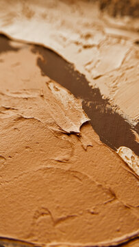 Close up shot of smooth beige and tan plaster applied on a decorative background. textured surface design, minimalistic interior finish, clay style wall putty.