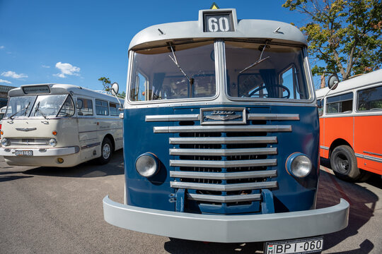 Vintage blue retro bus front view with chrome grille horizontal louvers and route number sixty sign at outdoor vehicle exhibition