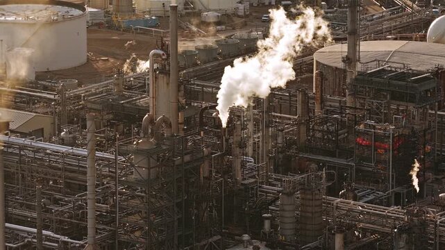 Refinery factory white smoke vapor coming out of chimney at sunset drone video, Denver, CO 4K