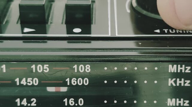 Searching for radio stations on an old radio recorder in a familiar setting