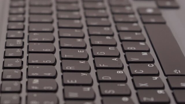 Remote work background with laptop keyboard , Macro shot of black computer keyboard buttons