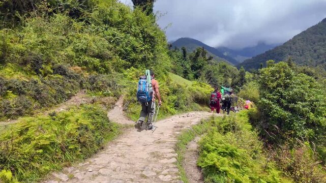 Trekkers With Backpacks Walking Stone Trail Toward Bedni Bugyal in Uttarakhand Himalayas