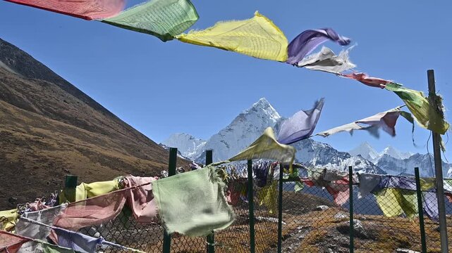 Mt.Ama Dablam (6,812 m) looking through the prayer flags hanging on Thukla pass a high mountain pass located in the Everest Trekking Region of Nepal.