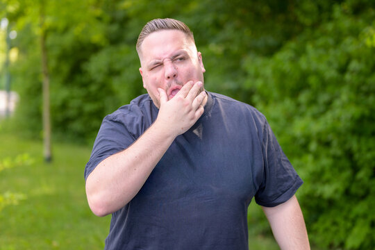 Sleepy Young Man Yawning Outdoors