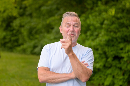 Confident Senior Pointing At Viewer