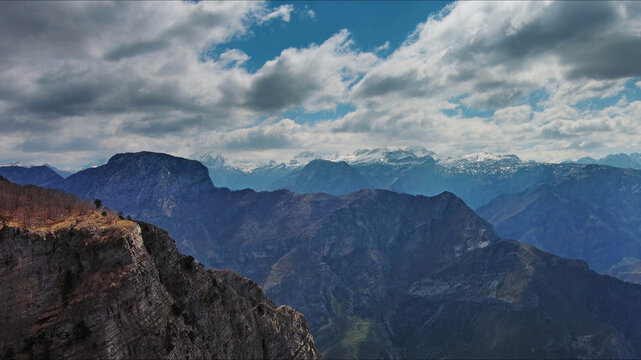 Aerial view of rocky mountain peak and green valley