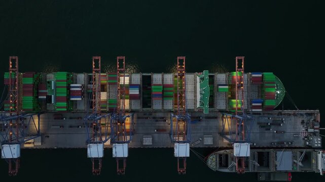 Aerial view container cargo ship loading unloading at night, Container cargo ship import export sea port, Global trade business container cargo ship freight shipping commercial trade logistic