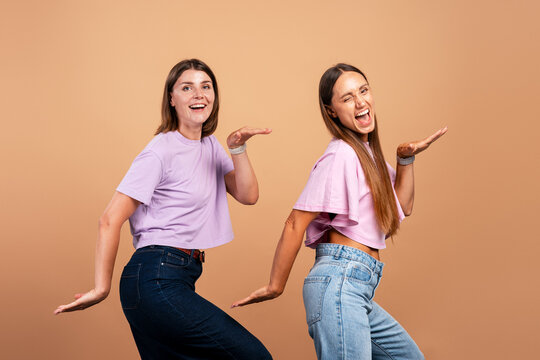 Happy women friends dancing together expressing joy and excitement