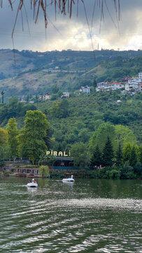 Pedal Boats Floating on Sera Lake with Lush Green Mountains and Lakeside Restaurant in Akcaabat, Trabzon, Northern Turkey