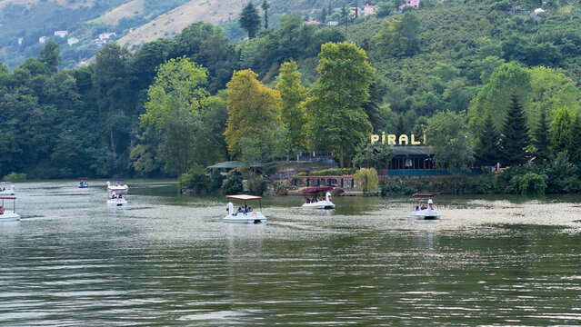 Pedal Boats Floating on Sera Lake with Lush Green Mountains and Lakeside Restaurant in Akcaabat, Trabzon, Northern Turkey