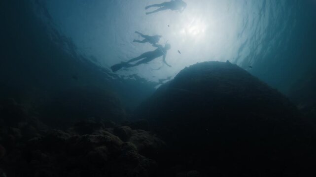 Underwater view of the family with kids snorkeling in the sea
