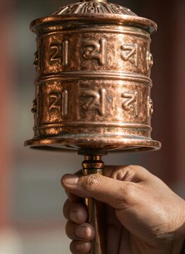 Captures Close Of Individuals Hand Holding Traditional Tibetan Prayer Wheel Made From Copper Adorned With Mantra Om Mani Padme Hum