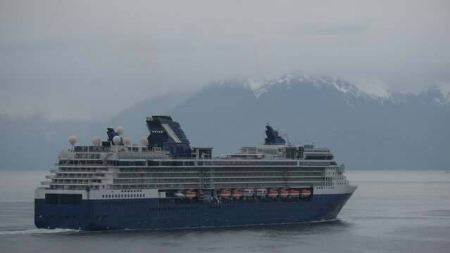 Breathtaking mountain glacier range view with luxury cruiseship cruise ship liner Summit sailing in front of Alaska mountains departure from Hoonah, Icy Strait Point with spectacular landscape scenery