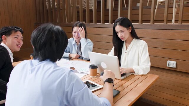 Asian Business Team Brainstorming on Outdoor Terrace